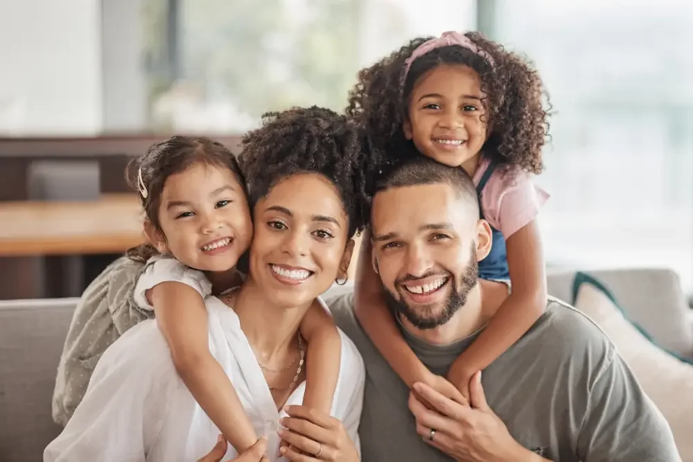 A family smiling together at home
